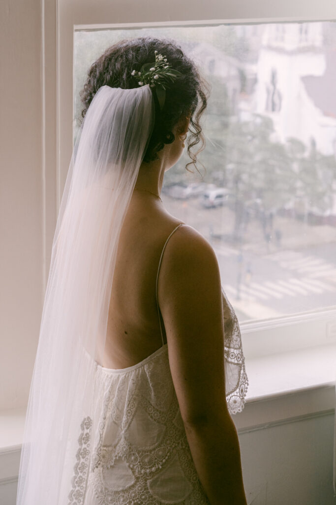 Bride looking out window of the Pontchartrain Hotel