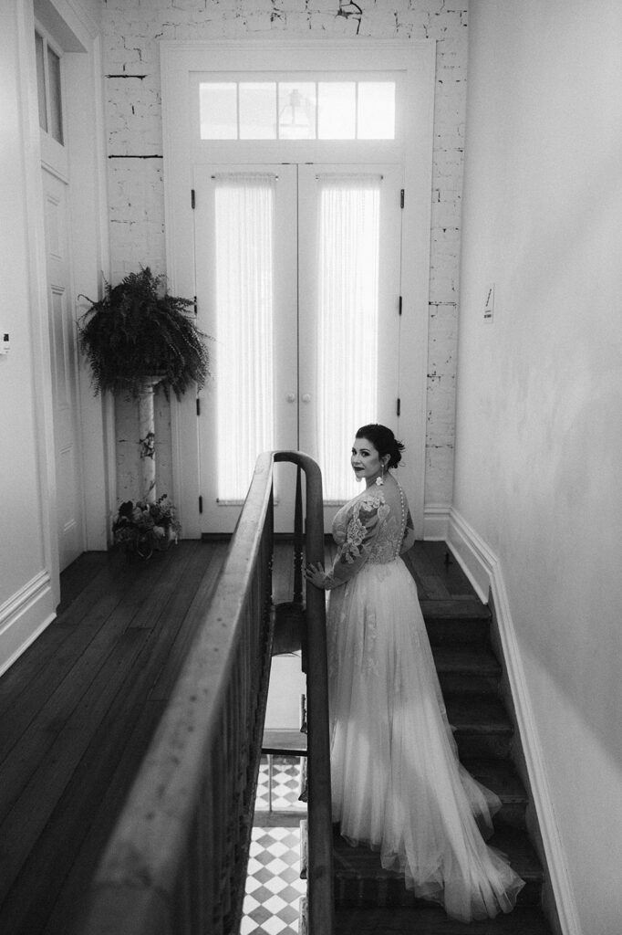 Bride on stairwell in the Hotel Peter and Paul in New Orleans