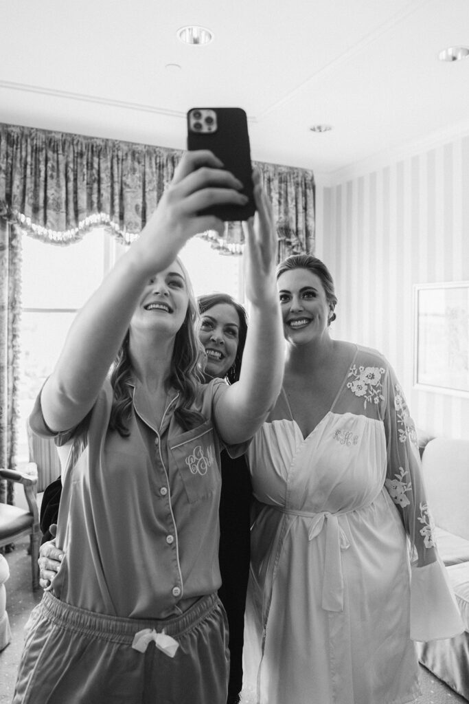 Bridesmaids with Bride taking a selfie on wedding day at the Hotel Monteleone in New Orleans