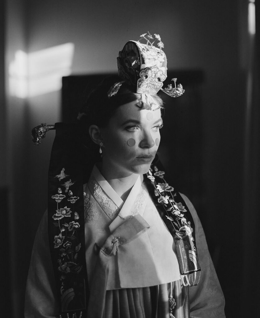 Bride dressed for Korean Ceremony photographed with traditional film wedding photography in black and white.