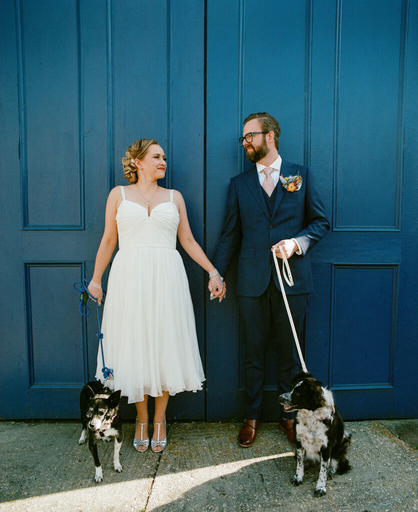 Bride and Groom with their doggies photographed with color film photography on their wedding day.