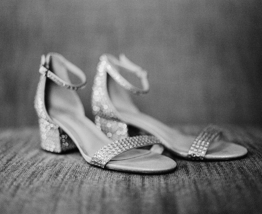 Brides shoes photographed with traditional black and white film photography.