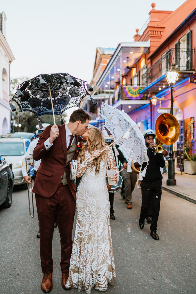 Couple kissing during second line parade just outside at Wedding in The New Orleans Pharmacy Museum